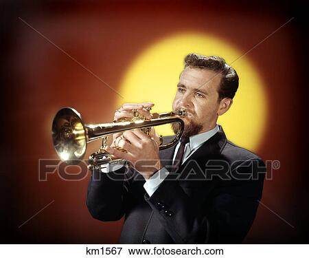 1960s man playing trumpet red yellow background View Large Photo Image Stock Photo - 1960s man playing trumpet red yellow background. Fotosearch