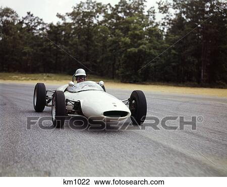 1960s man race car driver driving lotus ford sports car View Large Photo Image Stock Image - 1960s man race car driver driving lotus ford sports car. Fotosearch