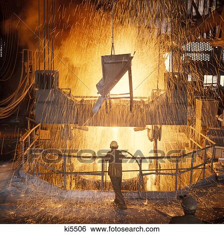 1960s man standing amid sparks of molten metal inside a steel mill View Large Photo Image Stock Photograph - 1960s man standing amid sparks of molten metal inside a steel mill. Fotosearch