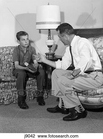 1960s man talking to son boy sitting chair couch book View Large Photo Image Stock Image - 1960s man talking to son boy sitting chair couch book. Fotosearch