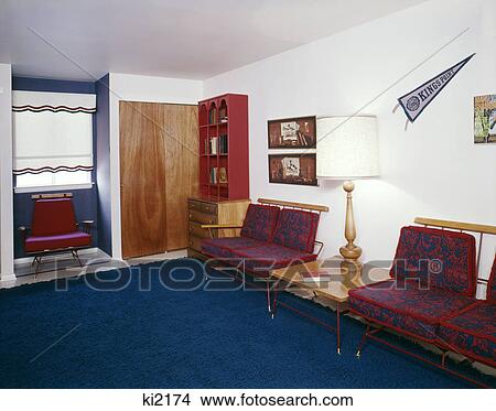 Picture - 1960s office waiting room blue carpet lamp end table school pennant. Fotosearch