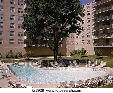 1960s outdoor swimming pool in apartment building complex View Large Photo Image Stock Photo - 1960s outdoor swimming pool in apartment building complex. Fotosearch