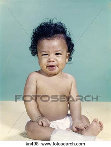Stock Photo - 1960s portrait african-american baby boy wearing diaper smiling making facial expression. Fotosearch