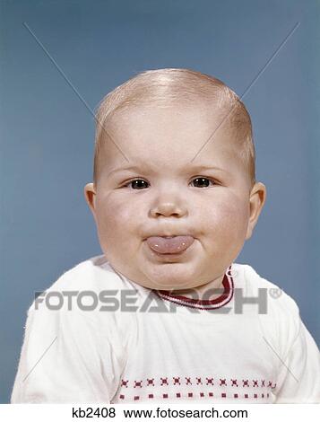 1960s portrait of cute blond chubby baby sticking out tongue View Large Photo Image Stock Photo - 1960s portrait of cute blond chubby baby sticking out tongue. Fotosearch
