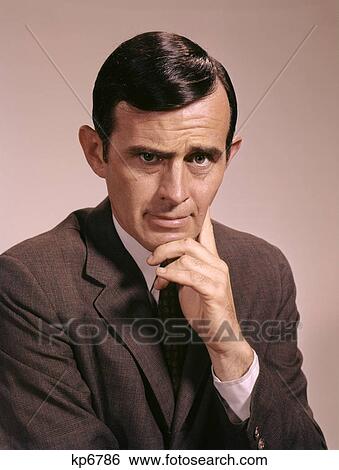 1960s portrait of serious businessman gesturing with hand to chin View Large Photo Image Stock Photograph - 1960s portrait of serious businessman gesturing with hand to chin. Fotosearch