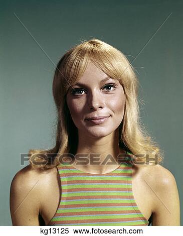 Stock Photography - 1960s portrait of young blond woman smiling wearing striped sleeveless top. Fotosearch