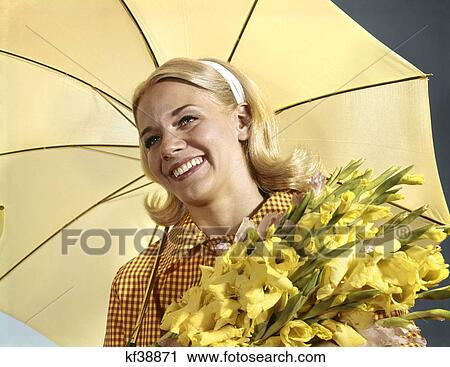 1960s portrait young blond woman hold bouquet yellow gladiolas under umbrella spring View Large Photo Image Stock Image - 1960s portrait young blond woman hold bouquet yellow gladiolas under umbrella spring. Fotosearch