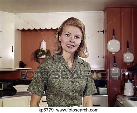 1960s portrait young blond woman in kitchen smiling View Large Photo Image Stock Photo - 1960s portrait young blond woman in kitchen smiling. Fotosearch