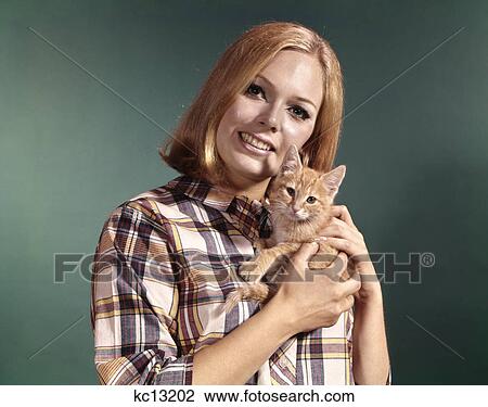 1960s portrait young blond woman wear madras plaid shirt head holding red tabby kitten pet View Large Photo Image Stock Image - 1960s portrait young blond woman wear madras plaid shirt head holding red tabby kitten pet. Fotosearch