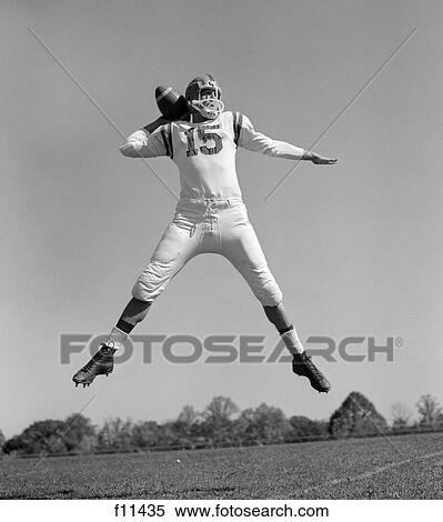1960s quarterback jumping and throwing pass football View Large Photo Image Stock Photography - 1960s quarterback jumping and throwing pass football. Fotosearch
