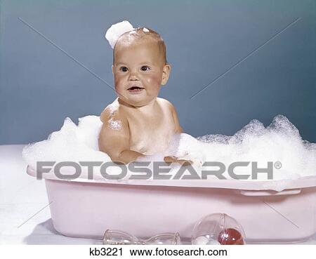 1960s smiling baby in bathtub covered with bubbles View Large Photo Image Stock Image - 1960s smiling baby in bathtub covered with bubbles. Fotosearch