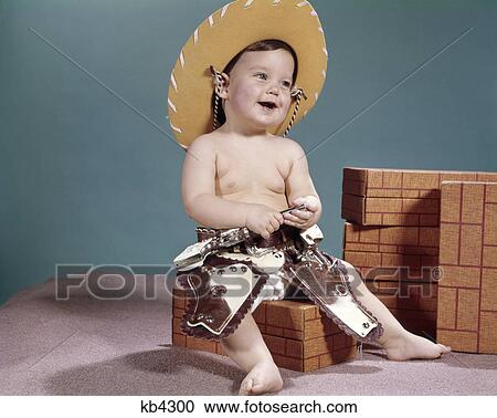 1960s smiling baby wearing cowboy hat and costume View Large Photo Image Stock Image - 1960s smiling baby wearing cowboy hat and costume. Fotosearch
