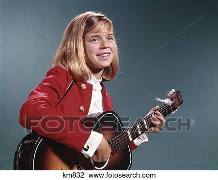 1960s smiling blond teenaged girl playing acoustic guitar View Large Photo Image Stock Image - 1960s smiling blond teenaged girl playing acoustic guitar. Fotosearch