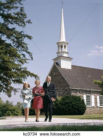 1960s smiling family leaving church each carrying bible View Large Photo Image Picture - 1960s smiling family leaving church each carrying bible. Fotosearch