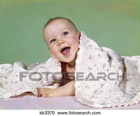 1960s smiling happy baby peeking out from under a blanket View Large Photo Image Stock Image - 1960s smiling happy baby peeking out from under a blanket. Fotosearch