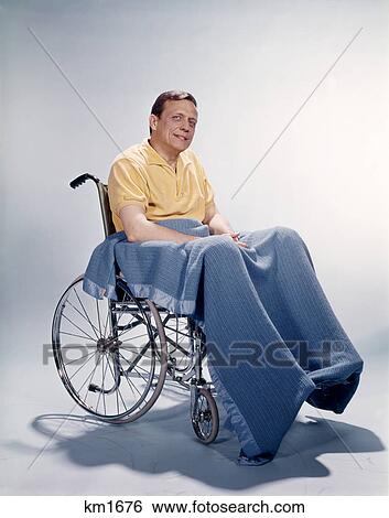 1960s smiling man sitting in wheelchair blanket wrapped around legs View Large Photo Image Stock Photograph - 1960s smiling man sitting in wheelchair blanket wrapped around legs. Fotosearch