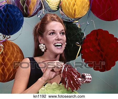 1960s smiling woman big pearl earrings holding noisemaker background of party decorations View Large Photo Image Stock Image - 1960s smiling woman big pearl earrings holding noisemaker background of party decorations. Fotosearch