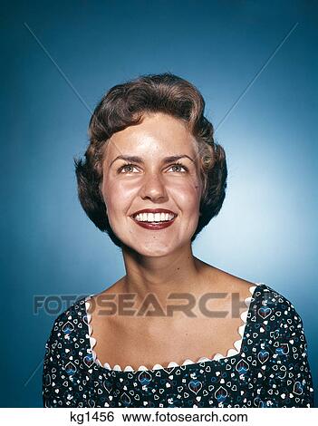 1960s smiling woman in print dress looking up studio View Large Photo Image Stock Photograph - 1960s smiling woman in print dress looking up studio. Fotosearch