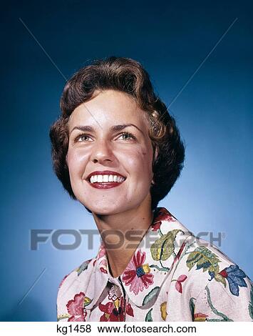 1960s smiling woman in white print dress looking up studio View Large Photo Image Stock Photo - 1960s smiling woman in white print dress looking up studio. Fotosearch