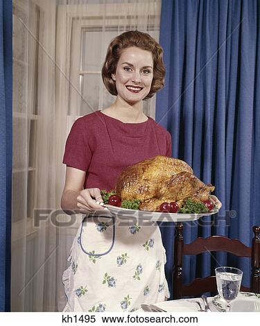 1960s smiling woman serving thanksgiving turkey dinner View Large Photo Image Stock Photography - 1960s smiling woman serving thanksgiving turkey dinner. Fotosearch