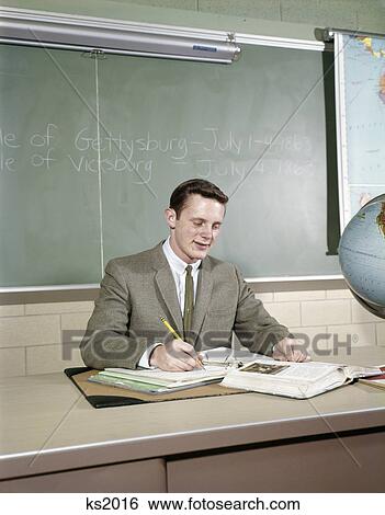 1960s student studying desk globe open book writing chalkboard high school View Large Photo Image Stock Photograph - 1960s student studying desk globe open book writing chalkboard high school. Fotosearch