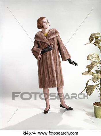 1960s stylish woman wearing fur mink coat full length fashion View Large Photo Image Picture - 1960s stylish woman wearing fur mink coat full length fashion. Fotosearch
