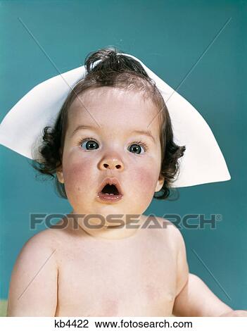 1960s surprised baby facial expression wearing a nurse cap View Large Photo Image Stock Image - 1960s surprised baby facial expression wearing a nurse cap. Fotosearch