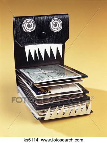 1960s symbolic monster wallet with wild eyes and sharp teeth filled with credit cards View Large Photo Image Picture - 1960s symbolic monster wallet with wild eyes and sharp teeth filled with credit cards. Fotosearch