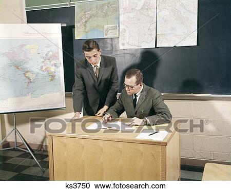 1960s teacher student conference desk teen maps high school man View Large Photo Image Stock Image - 1960s teacher student conference desk teen maps high school man. Fotosearch
