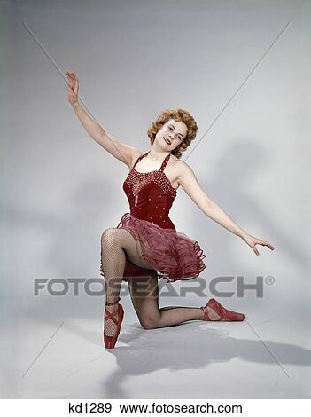 1960s teen girl red velvet costume pink net tutu kneeling ballet dance pose bow View Large Photo Image Stock Photo - 1960s teen girl red velvet costume pink net tutu kneeling ballet dance pose bow. Fotosearch
