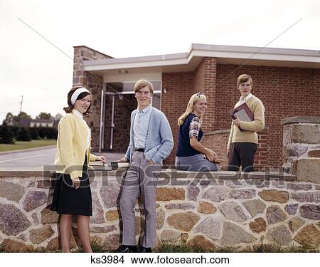 1960s teen students on campus boys girls couples by stone wall group View Large Photo Image Picture - 1960s teen students on campus boys girls couples by stone wall group. Fotosearch