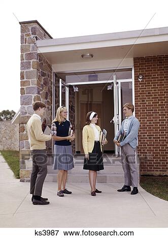 1960s teen students standing at entrance to school boys girls couples group View Large Photo Image Stock Photo - 1960s teen students standing at entrance to school boys girls couples group. Fotosearch