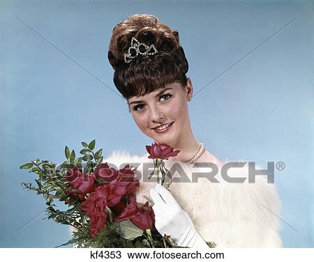 1960s teenage beauty queen holding red roses wearing fur stole and tiara View Large Photo Image Stock Image - 1960s teenage beauty queen holding red roses wearing fur stole and tiara. Fotosearch