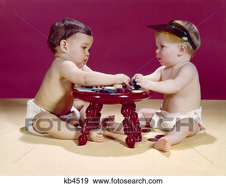 1960s two babies sitting at red stool playing cards poker with gambling chips View Large Photo Image Stock Photo - 1960s two babies sitting at red stool playing cards poker with gambling chips. Fotosearch