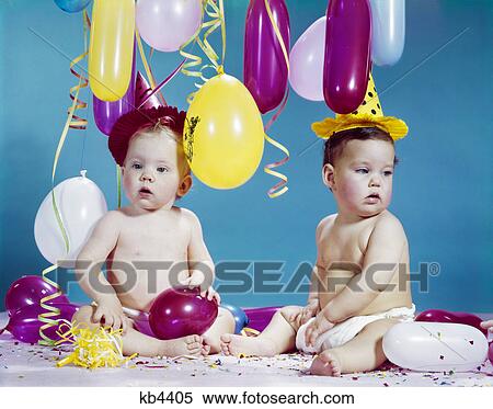 1960s two babies wearing party hats with balloons streamers confetti View Large Photo Image Stock Photography - 1960s two babies wearing party hats with balloons streamers confetti. Fotosearch
