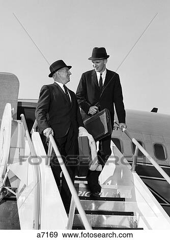 1960s two business men briefcase exit airplane steps View Large Photo Image Stock Photo - 1960s two business men briefcase exit airplane steps. Fotosearch