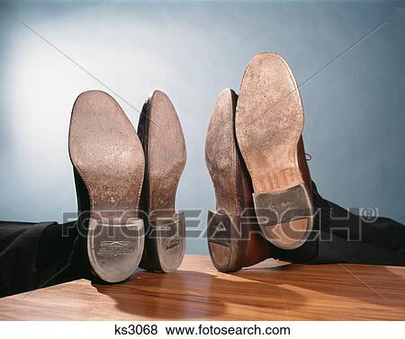 1960s two pairs of feet up on desk View Large Photo Image Stock Photo - 1960s two pairs of feet up on desk. Fotosearch