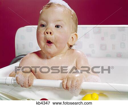 1960s wet baby in bath making funny face View Large Photo Image Stock Photo - 1960s wet baby in bath making funny face. Fotosearch