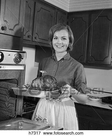 1960s woman kitchen dinner View Large Photo Image Stock Photo - 1960s woman kitchen dinner. Fotosearch