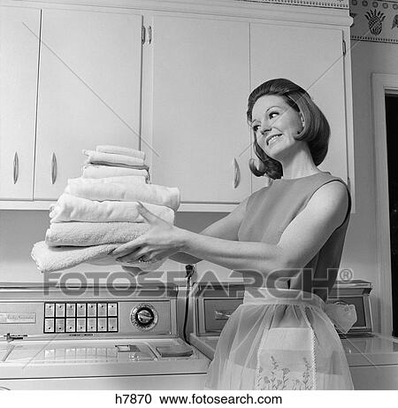 1960s woman laundry folded View Large Photo Image Stock Image - 1960s woman laundry folded. Fotosearch