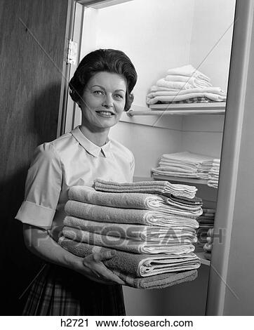1960s woman laundry folded towels View Large Photo Image Stock Image - 1960s woman laundry folded towels. Fotosearch