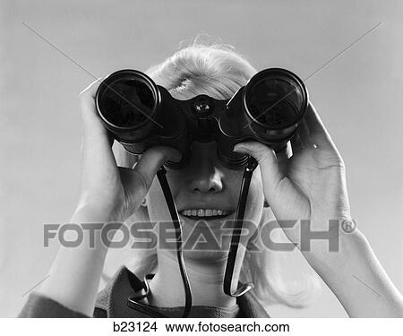 Picture - 1960s woman looking through binoculars. Fotosearch