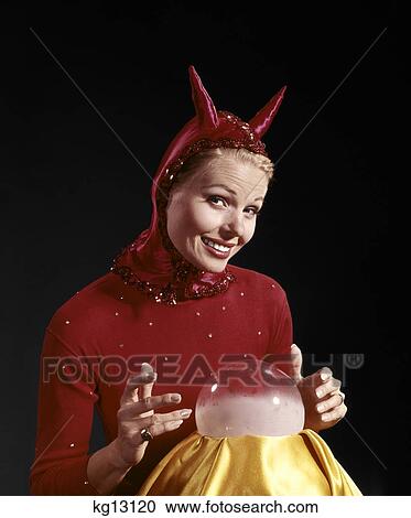 1960s woman wearing red devil costume with horns looking into crystal ball View Large Photo Image Stock Image - 1960s woman wearing red devil costume with horns looking into crystal ball. Fotosearch