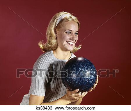 1960s young blond woman holding bowling ball wearing blue sweater View Large Photo Image Stock Image - 1960s young blond woman holding bowling ball wearing blue sweater. Fotosearch