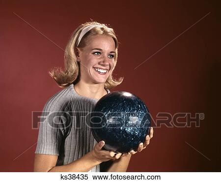 1960s young blond woman holding bowling ball wearing blue sweater View Large Photo Image Stock Photography - 1960s young blond woman holding bowling ball wearing blue sweater. Fotosearch