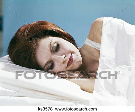 Stock Photo - 1960s young brunette woman sleeping smiling. Fotosearch