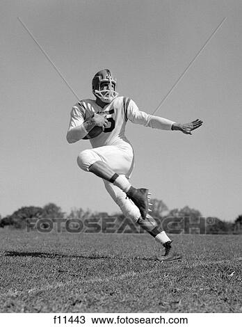 1960s young man football player running with ball View Large Photo Image Stock Image - 1960s young man football player running with ball. Fotosearch
