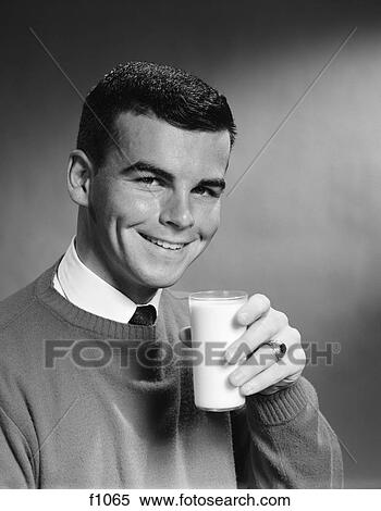 1960s young man smiling holding glass of milk View Large Photo Image Stock Photography - 1960s young man smiling holding glass of milk. Fotosearch