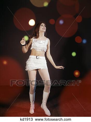 1960s young woman dancing among lights wearing mini skirt and fringed short top indoor boots disco View Large Photo Image Stock Image - 1960s young woman dancing among lights wearing mini skirt and fringed short top indoor boots disco. Fotosearch