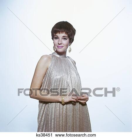 1960s young woman wear pleated metallic dress pixie hair earrings bracelet View Large Photo Image Stock Image - 1960s young woman wear pleated metallic dress pixie hair earrings bracelet. Fotosearch